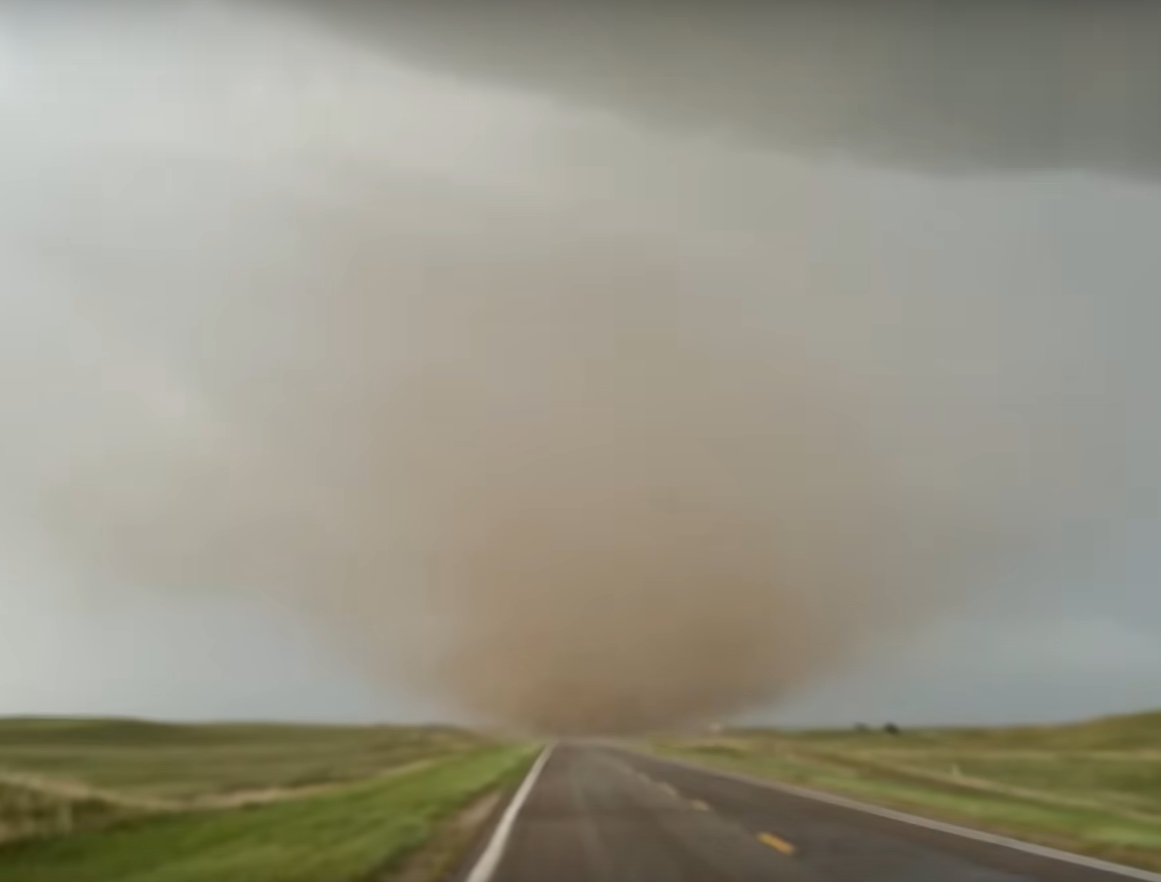 A substantial tornado debris cloud coming up from the ground.  No
vapor funnel is visible.